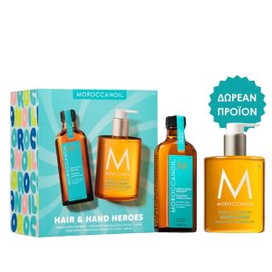 Moroccanoil Hair & Hand Heroes gift set with three orange bottles and teal labels, plus a teal ‘Free Product’ badge on the right.