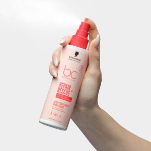 Χέρι κρατά το Schwarzkopf Professional Bonacure Repair Rescue+ Spray Conditioner 200ml.