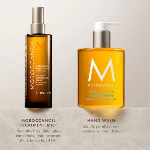 Two Moroccanoil bottles on a display: Treatment Mist (left) and Hand Wash (right).