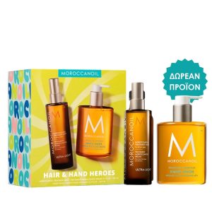 Moroccanoil hair and hand heroes kit with three amber bottles and a bright yellow box, plus a 'free product' badge.