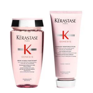 Two pink Kerastase Genesis hair care bottles—fortifying shampoo and fortifying conditioner for weakened hair.